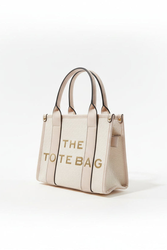 Beige tote bag with 'THE TOTE BAG' text on a white background