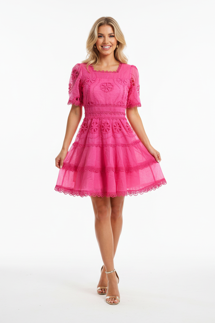 Woman wearing a pink dress on a white background