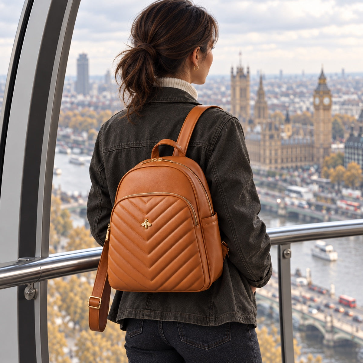 Woman with a caramel quilted backpack looking over London from the London Eye, SinglePrice
