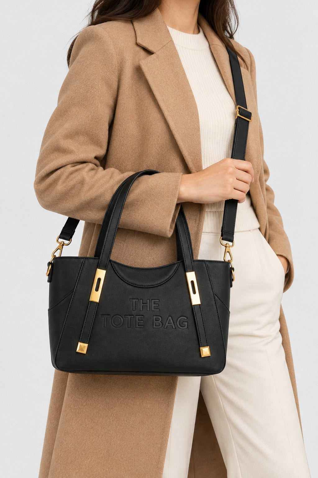 Embossed Slogan Gold Hardware Tote Bag - BLACK carried by model with crossbody strap