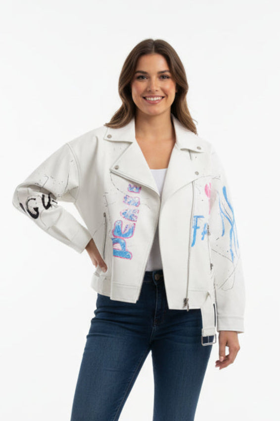 Woman wearing a white jacket with colorful text and blue jeans on a white background