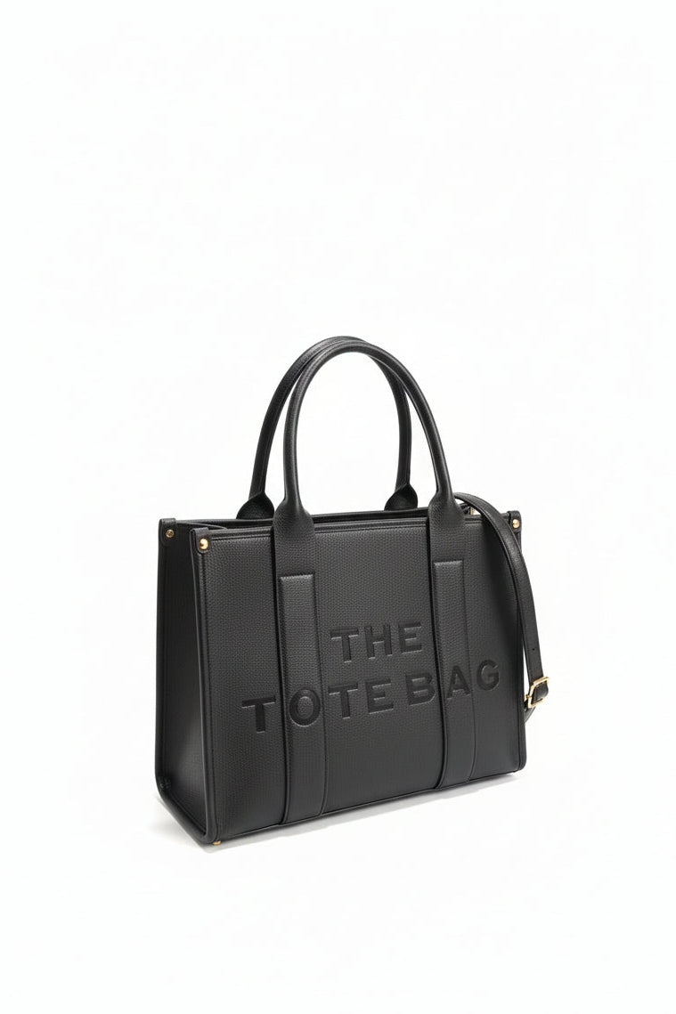 Black tote bag with 'THE TOTE BAG' text on a white background