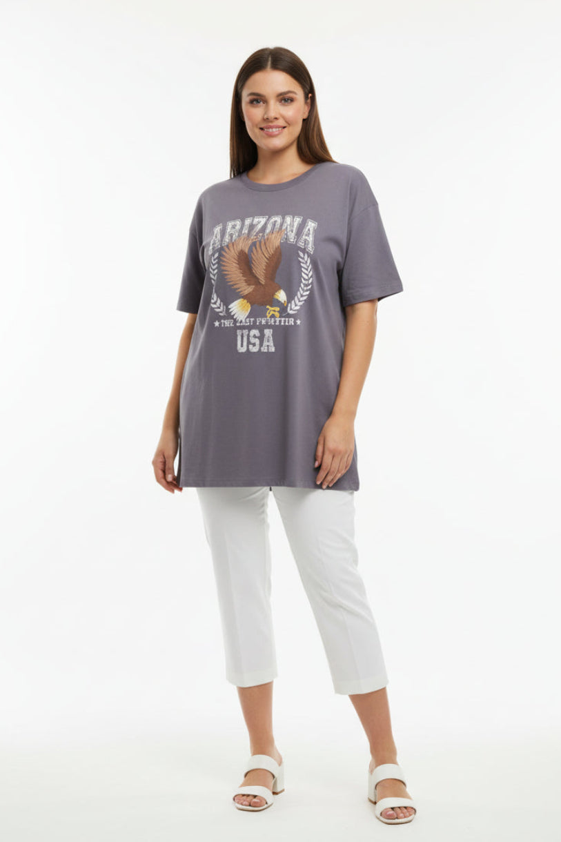 Woman wearing a gray 'Arizona' t-shirt and white pants on a white background