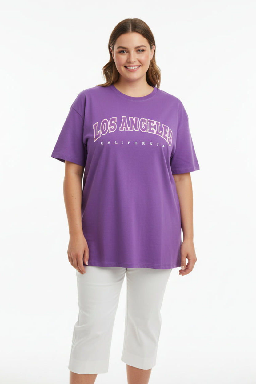 Woman wearing a purple 'Los Angeles California' t-shirt on a white background