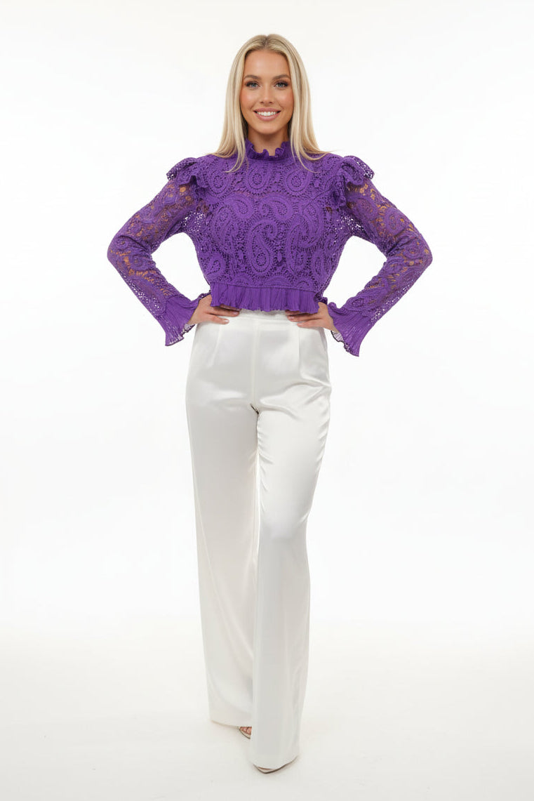 Purple lace garment on a stand in a warehouse setting