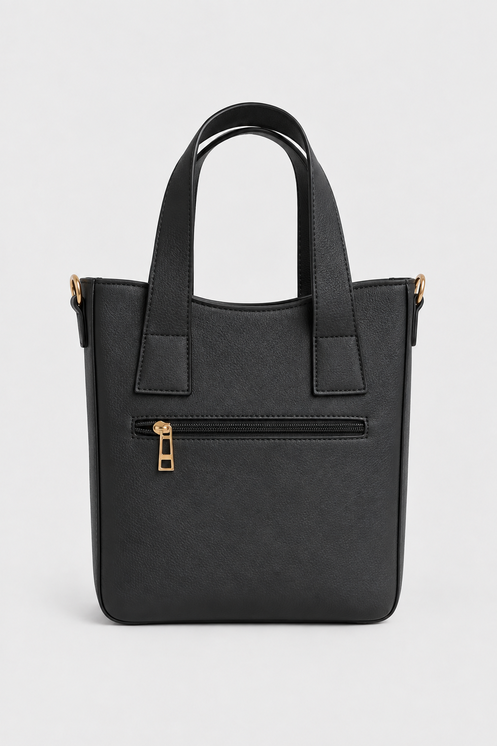 Black PU tote bag showing rear zipped pocket and twin handles